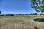 Discover this expansive property featuring a large, open grassy field perfect for outdoor activities or future development.