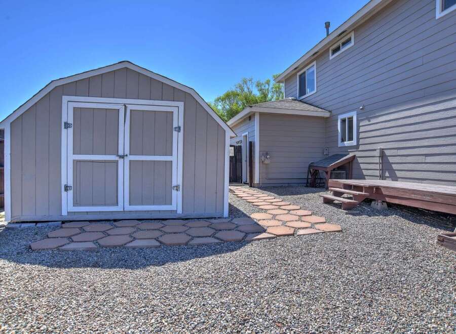 Discover this charming backyard featuring a spacious shed, perfect for storage or a workshop.