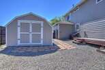 Discover this charming backyard featuring a spacious shed, perfect for storage or a workshop.