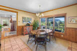 Enjoy breathtaking mountain views from this charming dining room, featuring a rustic wooden table and chairs perfect for intimate gatherings.