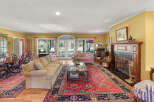 Step into this elegant living room featuring a grand piano and a cozy fireplace, perfect for entertaining.