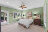 This charming bedroom features a comfortable queen-size bed adorned with a white quilted comforter and floral accent pillows.
