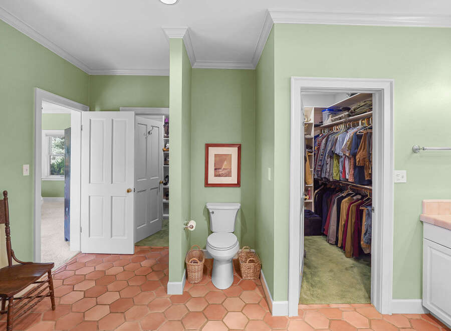 Discover a unique bathroom layout featuring a toilet and a spacious walk-in closet, perfect for organizing your wardrobe.