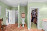 Discover a unique bathroom layout featuring a toilet and a spacious walk-in closet, perfect for organizing your wardrobe.