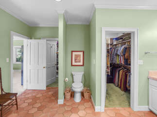Discover a unique bathroom layout featuring a toilet and a spacious walk-in closet, perfect for organizing your wardrobe.