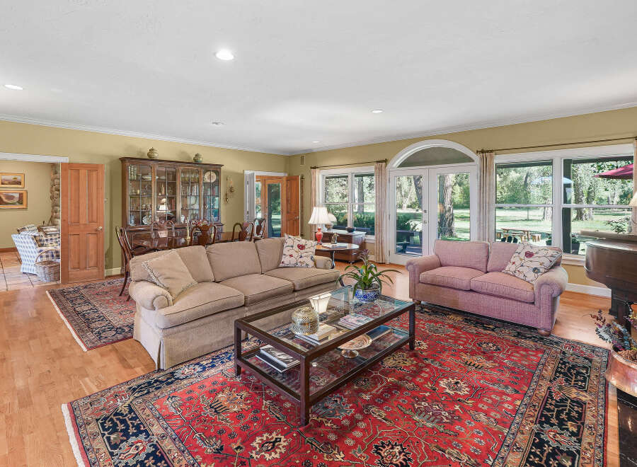 Step into this elegant living room, featuring a large sectional sofa and a plush pink sofa perfect for relaxation.