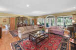 Step into this elegant living room, featuring a large sectional sofa and a plush pink sofa perfect for relaxation.