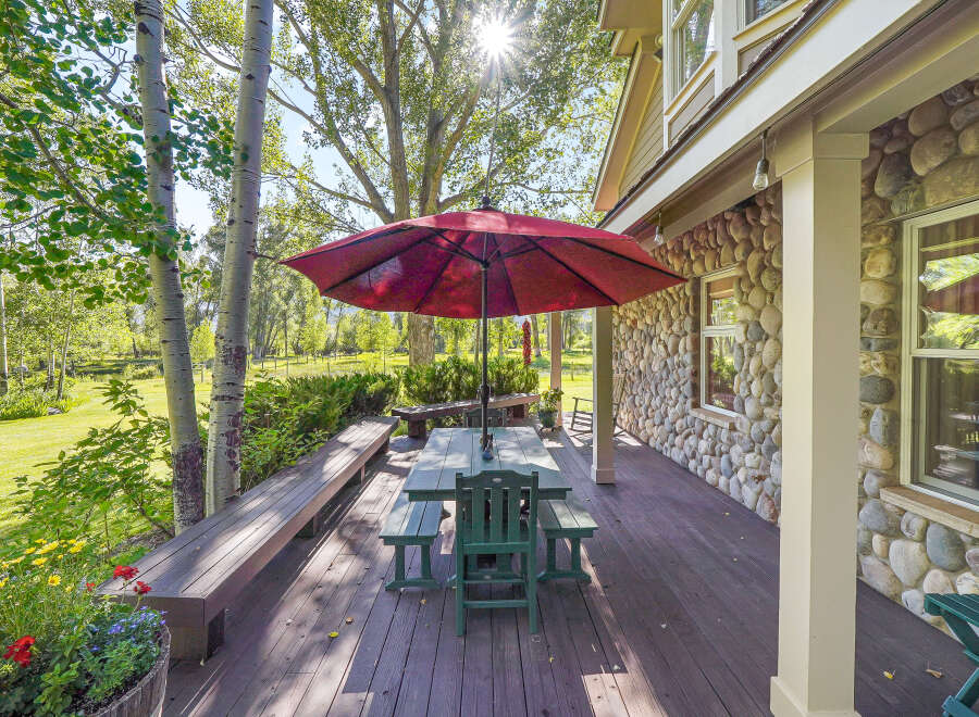Enjoy outdoor living on this spacious deck, perfect for entertaining or relaxing amidst nature.