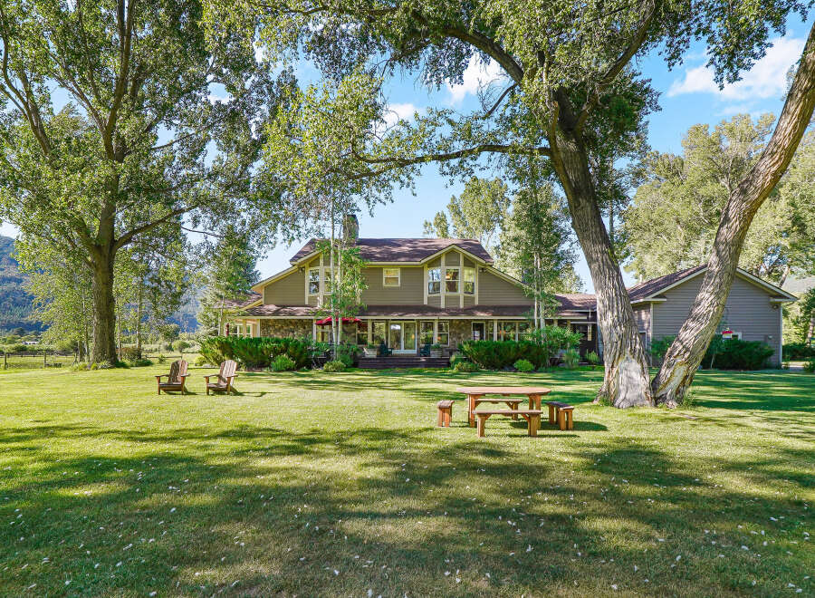 Experience serene country living with this stunning property featuring a spacious home nestled amidst mature trees and lush green lawns.