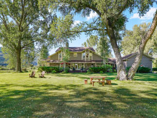 Experience serene country living with this stunning property featuring a spacious home nestled amidst mature trees and lush green lawns.