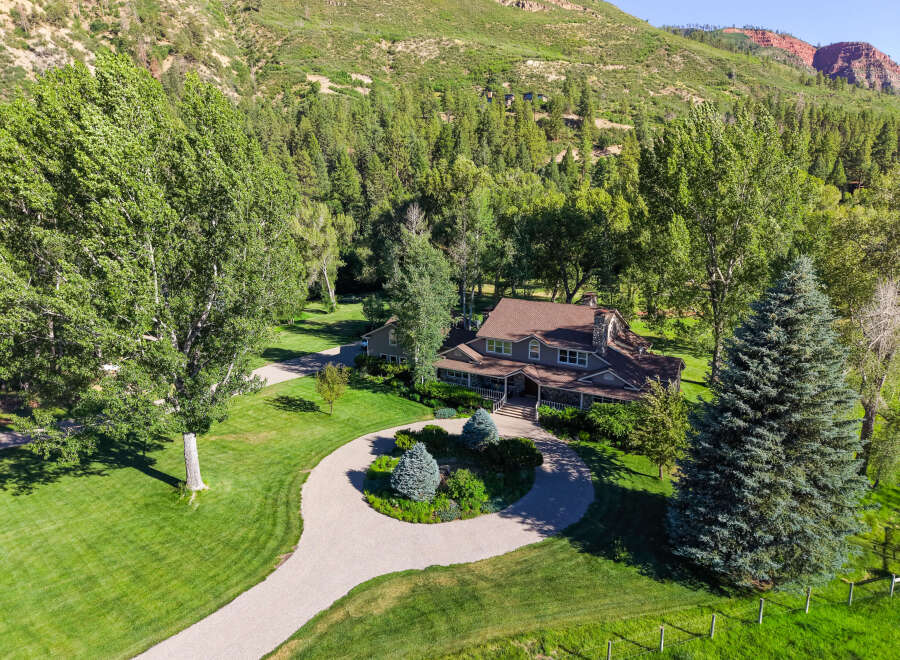 Nestled amidst a lush forest and rolling hills, this stunning property offers a serene retreat.