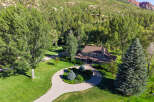 Nestled amidst a lush forest and rolling hills, this stunning property offers a serene retreat.