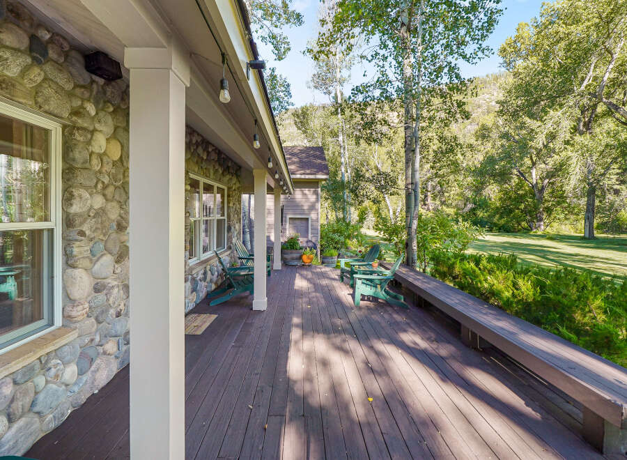 Enjoy the serene mountain setting from this expansive wooden deck, perfect for outdoor living.