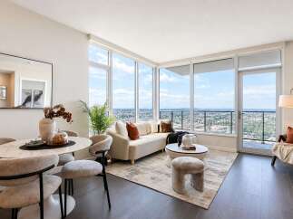 Experience modern living in this stunning apartment featuring a spacious living and dining area with breathtaking panoramic city views.