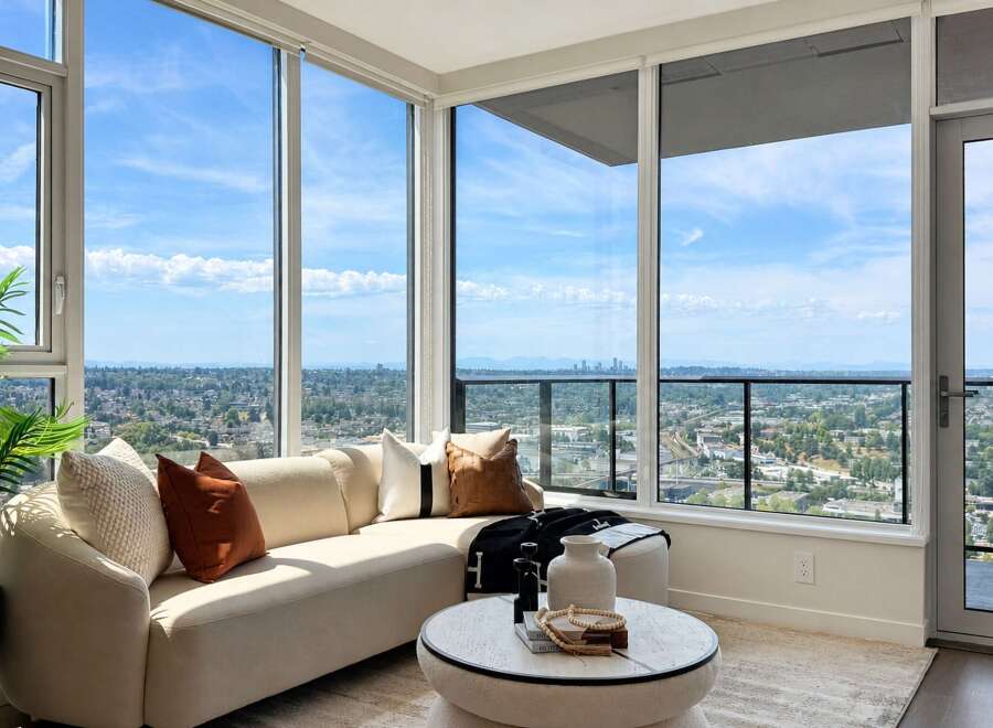 Experience breathtaking panoramic views from this stunning living room, featuring floor-to-ceiling windows that flood the space with natural light.