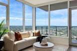 Experience breathtaking panoramic views from this stunning living room, featuring floor-to-ceiling windows that flood the space with natural light.