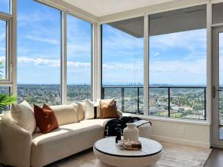 Experience breathtaking panoramic views from this stunning living room, featuring floor-to-ceiling windows that flood the space with natural light.