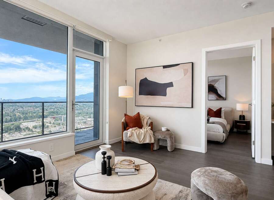 Experience modern living in this stunning apartment featuring expansive floor-to-ceiling windows that offer breathtaking city and mountain views.