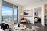 Experience modern living in this stunning apartment featuring expansive floor-to-ceiling windows that offer breathtaking city and mountain views.