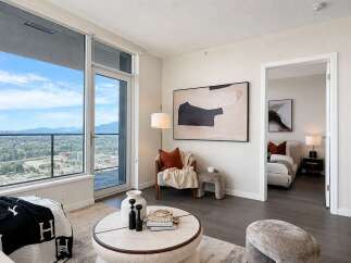 Experience modern living in this stunning apartment featuring expansive floor-to-ceiling windows that offer breathtaking city and mountain views.