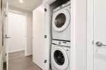 Discover modern convenience with this stacked Samsung washer and dryer set, perfectly integrated into a compact laundry closet.