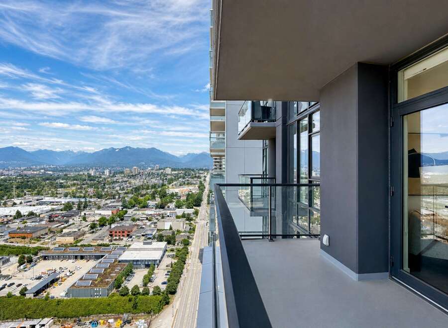 Experience breathtaking panoramic views from this stunning balcony, offering a sweeping vista of the city and majestic mountains.