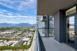 Experience breathtaking panoramic views from this stunning balcony, offering a sweeping vista of the city and majestic mountains.