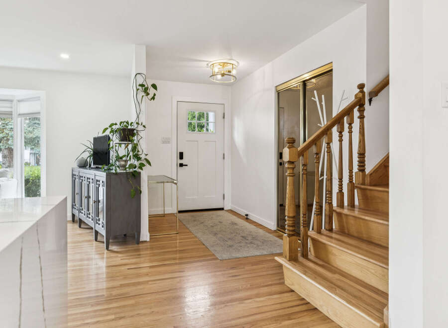 Step into this inviting entryway featuring gleaming hardwood floors and a bright, open layout.