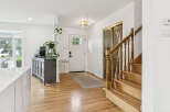Step into this inviting entryway featuring gleaming hardwood floors and a bright, open layout.