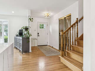 Step into this inviting entryway featuring gleaming hardwood floors and a bright, open layout.