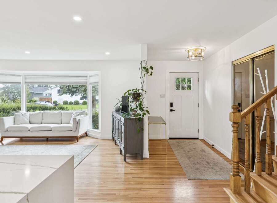 Step into this bright and airy living space, featuring a large bay window that floods the room with natural light.