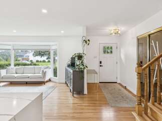 Step into this bright and airy living space, featuring a large bay window that floods the room with natural light.