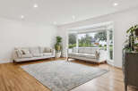 Step into this bright and airy living room, featuring a large bay window that floods the space with natural light.