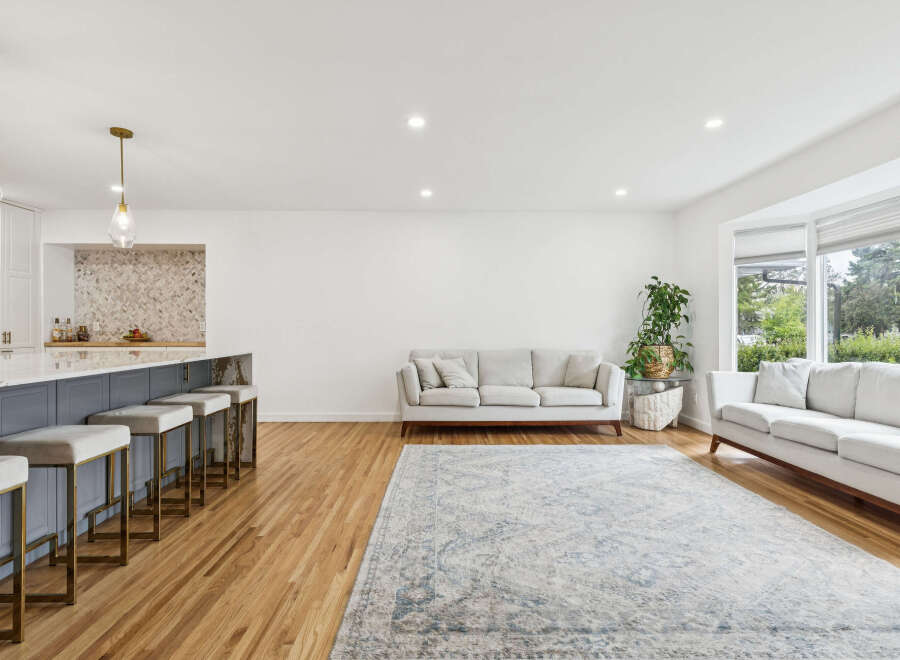 Experience modern living in this spacious open-concept home featuring a sleek kitchen island with bar seating and elegant pendant lighting.