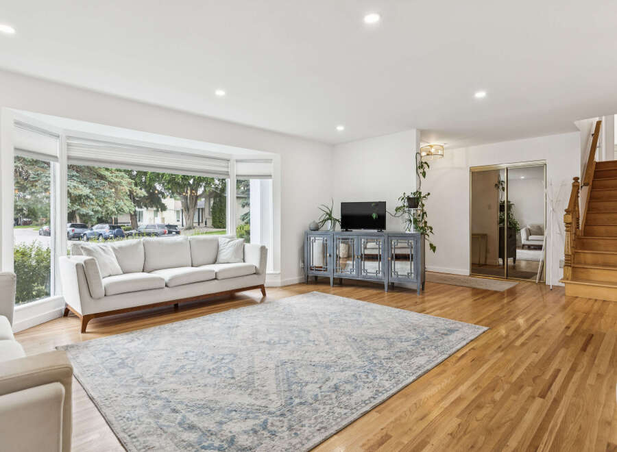 Step into this bright and airy living room, featuring a large bay window that floods the space with natural light.