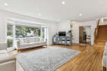 Step into this bright and airy living room, featuring a large bay window that floods the space with natural light.
