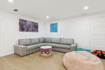 This inviting living space features a comfortable sectional sofa, perfect for family gatherings or relaxing evenings.