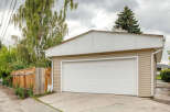 This property features a spacious two-car garage with a modern white overhead door, perfect for vehicle storage and workshop needs.