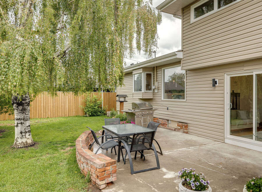 Enjoy outdoor living in this charming backyard featuring a spacious patio perfect for entertaining.