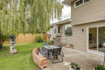 Enjoy outdoor living in this charming backyard featuring a spacious patio perfect for entertaining.