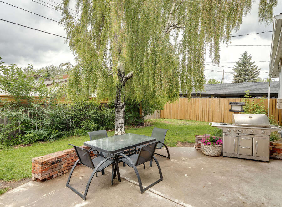 Enjoy outdoor living in this charming backyard featuring a spacious patio perfect for entertaining.