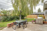 Enjoy outdoor living in this charming backyard featuring a spacious patio perfect for entertaining.