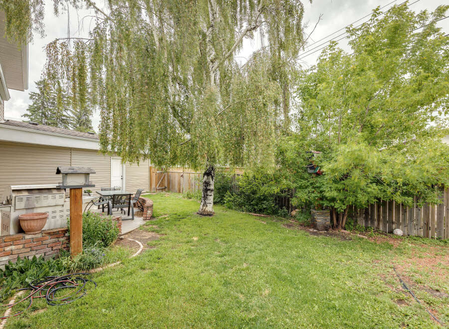 Enjoy outdoor living in this spacious backyard, complete with a built-in BBQ and a patio set perfect for al fresco dining.