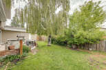 Enjoy outdoor living in this spacious backyard, complete with a built-in BBQ and a patio set perfect for al fresco dining.