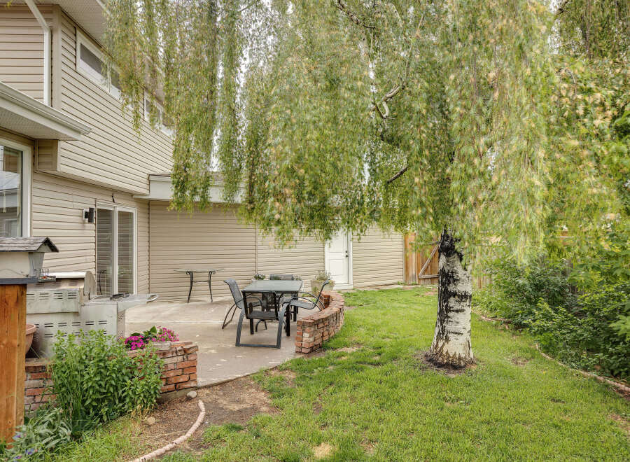 Enjoy outdoor living in this charming backyard featuring a spacious patio perfect for entertaining.