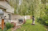 Enjoy outdoor living in this charming backyard featuring a spacious patio perfect for entertaining.