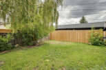 Enjoy outdoor living in this spacious backyard, complete with a lush green lawn and a newly fenced perimeter for privacy.