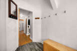 Welcome guests into this charming entryway featuring a decorative mirror with hooks for convenient storage.