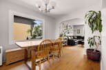 This inviting dining area features a rustic wooden table and chairs, perfect for family meals.