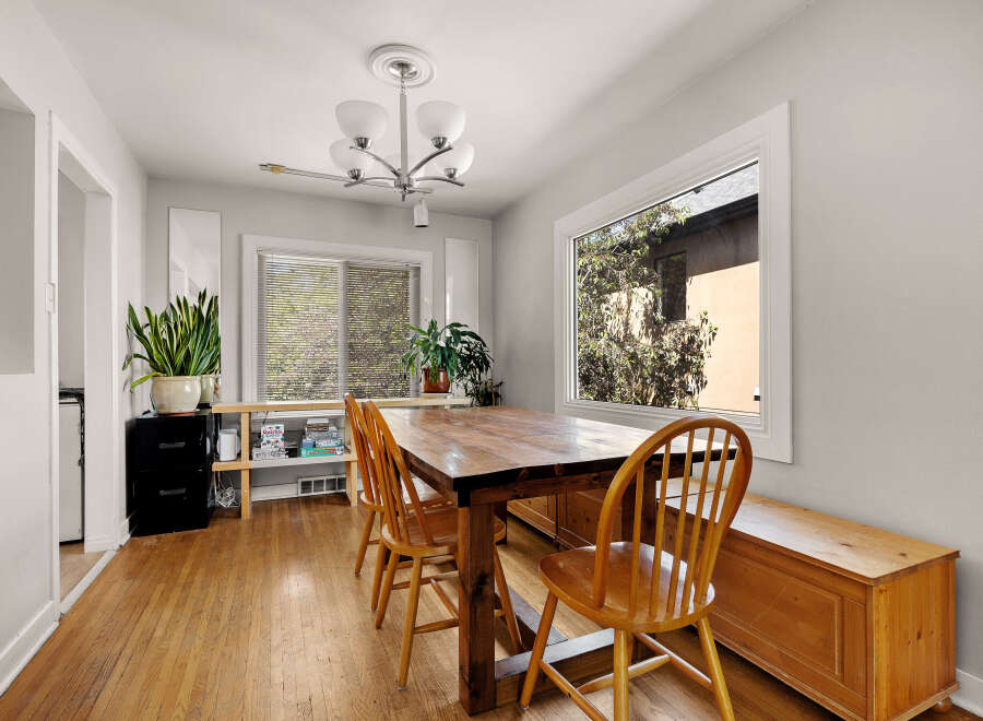 This charming dining area features a rustic wooden dining table with four matching chairs, perfect for family meals.